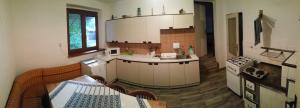 a kitchen with white cabinets and a table in it at Rodinný dom in Muránska Huta