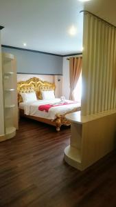 a bedroom with a large bed in a room at Sokdee City Hotel in Vientiane