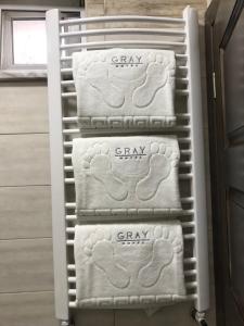a group of towels on a towel rack in a bathroom at Gray Hotel in Vynohradiv