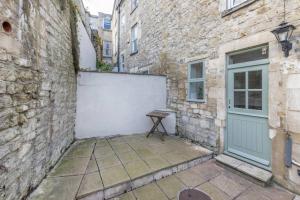 a bench sitting next to a building with a door at Ivory House - Stunning Central Townhouse in Bath