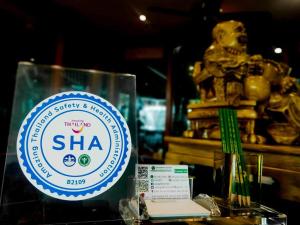 a glass container with a sha sign on a table at Viang Tak Riverside Hotel in Tak