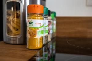 a group of jars of mustard sitting on a counter at Le Mille - Cosy appartement 4 personnes - 15mn du centre de Lyon in Villeurbanne