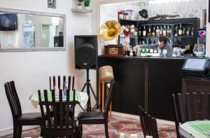 a man standing at a bar in a restaurant at Astoria Lux in Dnipro