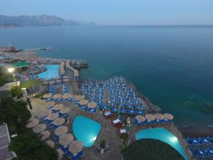 an aerial view of a resort with a pool and the ocean at Trsteno Beach Apartments in Budva