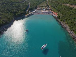 two boats in a large body of water at Trsteno Beach Apartments in Budva
