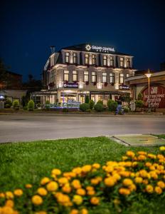 a building with a bunch of flowers in front of it at Grand Central Hotel in Bitola