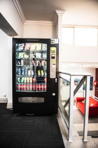 a vending machine in a building with drinks at The Emperors Crown Hostel in Perth