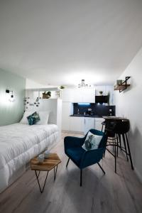 a bedroom with a bed and a table and a desk at La Suite Saint Georges - Beau studio cosy et design à 5 mn métro Vieux Lyon in Lyon