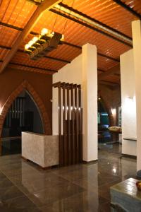 a lobby with a stone floor and a wooden ceiling at Nostravila in Lonavala