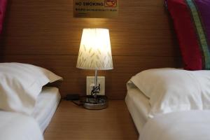 Säng eller sängar i ett rum på O' Hotel