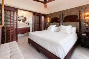 a hotel room with a bed and a dresser at Santa Catalina, a Royal Hideaway Hotel in Las Palmas de Gran Canaria