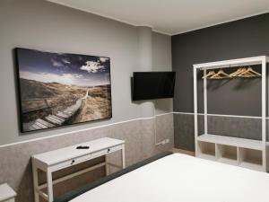 A bed or beds in a room at La Maison Latina Guest House