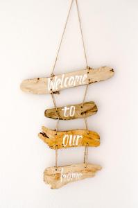 a wooden sign that says welcome to our home at Villa Elia II in Mélanes