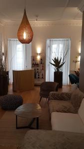 a living room with a couch and chairs and a lamp at Villa Zawaia B&B in Lagos