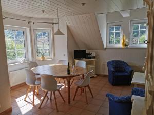 a dining room with a table and chairs at Apartments / Ferienwohnungen Moseluferstrasse in Neef