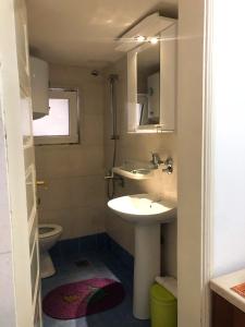 a bathroom with a sink and a toilet at Apartments Moracanin in Sutomore +38 photos