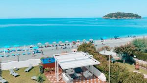 an aerial view of a beach with people and umbrellas at Villa Pietra Rossa in Diamante