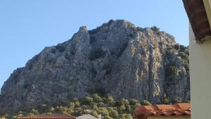 a large rocky mountain in front of a building at Kassandra Villa Nafplio in Asíni