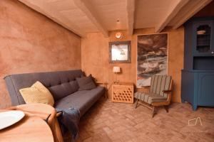 a living room with a couch and a chair at Heritage Stonehouse Jure in Krk