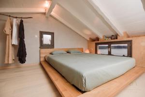 a bedroom with a large bed and a window at Heritage Stonehouse Jure in Krk +57 photos