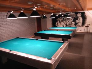 a row of pool tables in a room at Männimäe Guesthouse in Viljandi