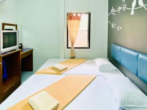 Postel nebo postele na pokoji v ubytování Phang Nga Guesthouse