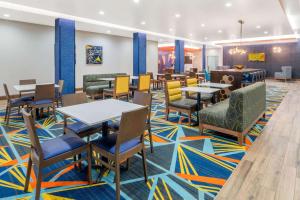 オクラホマシティにあるLa Quinta by Wyndham Oklahoma City Airportのレストラン内のダイニングルーム(テーブル、椅子付)