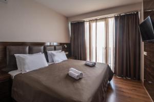 Postel nebo postele na pokoji v ubytování Orbi Beach Tower Hotel Official