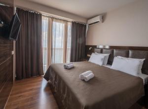 Postel nebo postele na pokoji v ubytování Orbi Beach Tower Hotel Official