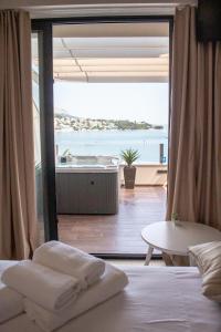 a bedroom with a view of the ocean and a tub at Luxury rooms ''Seven'' in Split