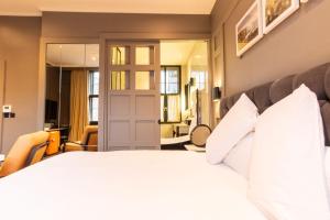 a bedroom with a large bed with white pillows at The Dean Dublin in Dublin