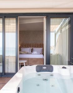 a bath tub in a room with a bed at Luxury rooms ''Seven'' in Split