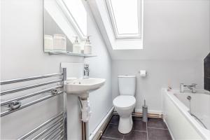 a white bathroom with a sink and a toilet at Guest Homes - Carriage Court in Worcester