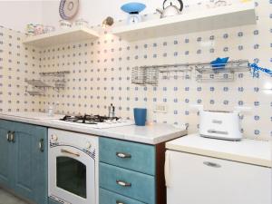 サンタガータ・スイ・ドゥエ・ゴルフィにあるHoliday Home Nulla di Troppo by Interhomeのキッチン(青いキャビネット、白いコンロ付)