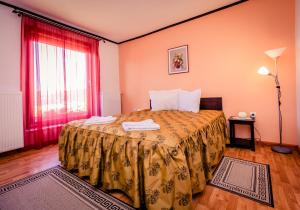 a bedroom with a bed and a red window at Panorama Guesthouse in Sighişoara