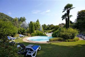 a swimming pool with lounge chairs in a yard at St. Maurice smile in Ghiffa
