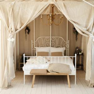 a bedroom with a white bed with a canopy at Vakantiewoning Loft Lisse - SAUNA - Beach - Keukenhof in Lisse