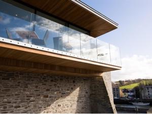 a building with glass windows on the side of it at Cardigan Castle in Cardigan