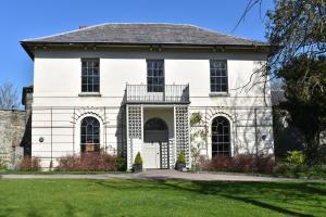 a white house with a black roof at Cardigan Castle in Cardigan