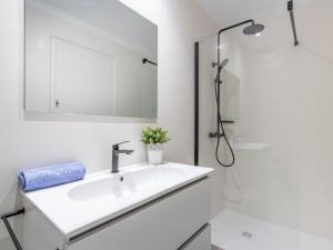 a white bathroom with a sink and a shower at Apartment Bahia I by Interhome in Empuriabrava