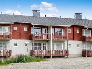 a red and white building with a lot of windows at Holiday Home Levi star 2- app- 409 by Interhome in Levi