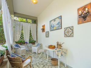 a living room with a table and chairs at Holiday Home Madda by Interhome in Lido di Camaiore