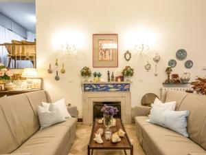 a living room with two couches and a fireplace at Holiday Home Madda by Interhome in Lido di Camaiore