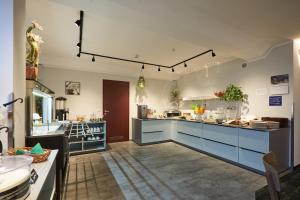 a large kitchen with blue cabinets and a counter at Hotel Anhalt in Brehna