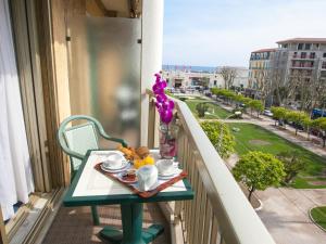 a table with a tray of food on a balcony at Hotel Chambord in Menton +29 photos