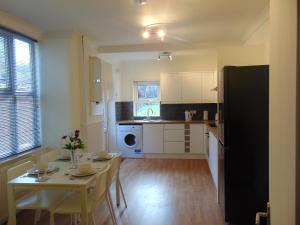 a kitchen with a table and a dining room at Ceres Lodge in Plumstead
