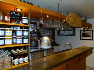 a bar with a counter with many bottles of alcohol at Chalet de la Yodine in Feissons-sur-Salins