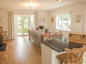 a kitchen and dining room with a table and chairs at The Big Dingle in Church Stretton