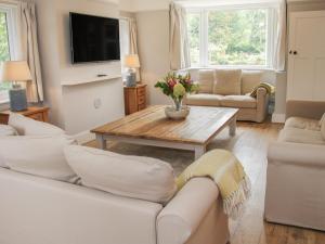 a living room with couches and a coffee table at The Big Dingle in Church Stretton