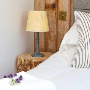 una lámpara en una mesa junto a una cama en Bird & Carter Fonthill, en Fonthill Bishop